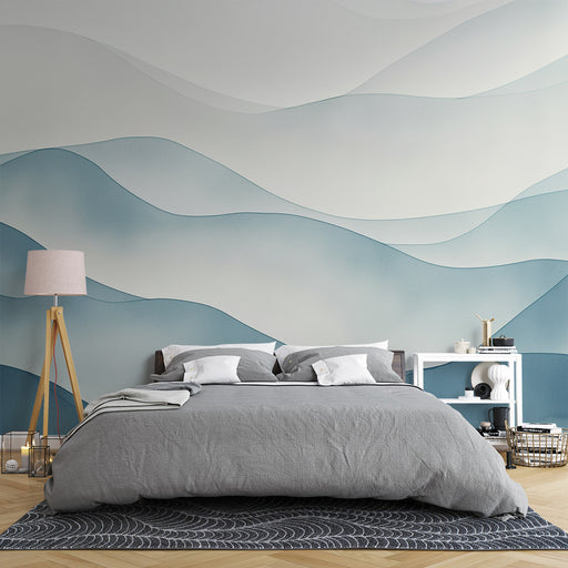 Une chambre apaisante avec un papier peint aux ondulations bleu clair et gris évoquant des vagues, créant une atmosphère sereine et moderne.