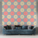 Papier peint moderne avec motifs circulaires rose et beige sur fond bleu pour salon élégant.