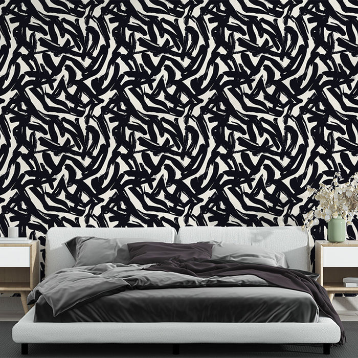 Une chambre moderne avec un papier peint abstrait noir et blanc aux motifs dynamiques, créant une ambiance artistique et contemporaine.