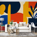 Papier peint abstrait avec motifs géométriques colorés et plante stylisée pour salon moderne.