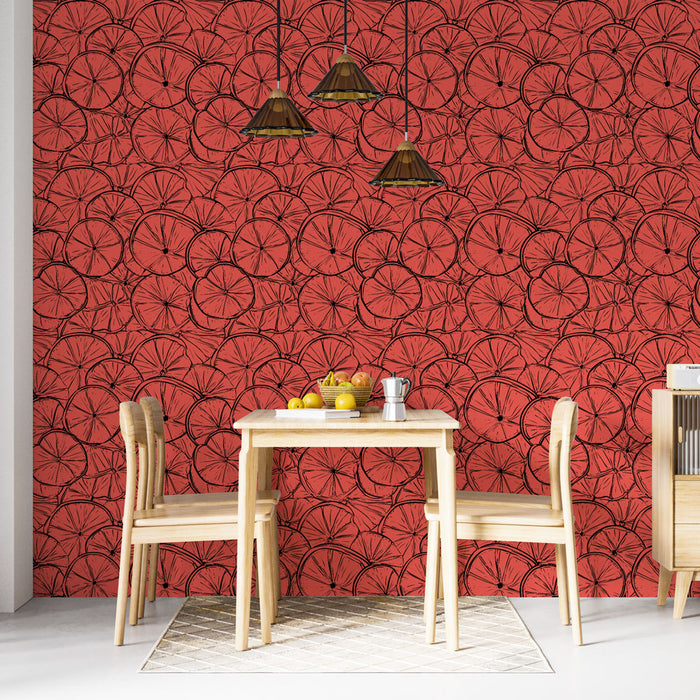 Une salle à manger lumineuse avec un papier peint rouge vif orné de motifs de rondelles de fruits, créant une ambiance joyeuse et dynamique.
