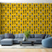 Un salon moderne avec un papier peint jaune vif orné de motifs d'ananas noirs et blancs, créant une ambiance joyeuse et estivale.