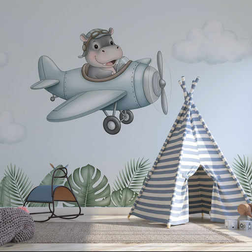 Une chambre d'enfant avec un papier peint illustratif représentant un hippopotame joyeux dans un avion, créant une ambiance ludique et imaginative.