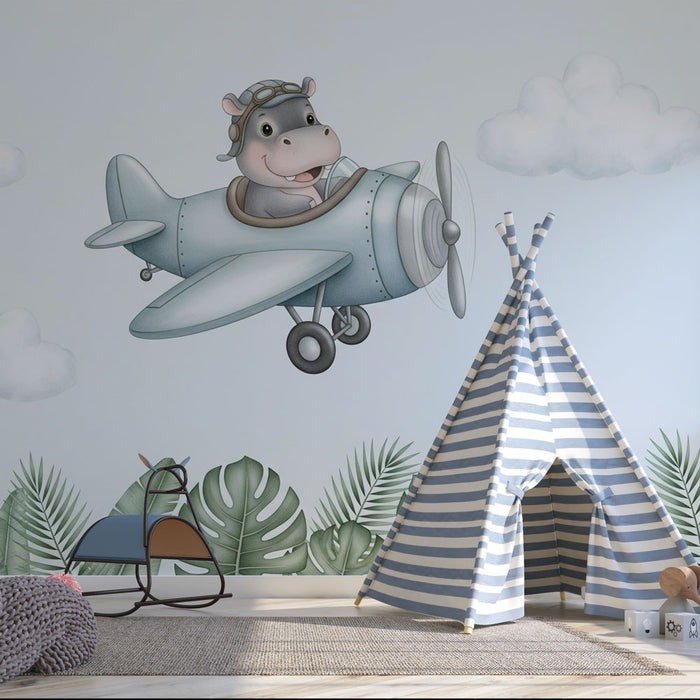 Une chambre d'enfant avec un papier peint illustratif représentant un hippopotame joyeux dans un avion, créant une ambiance ludique et imaginative.