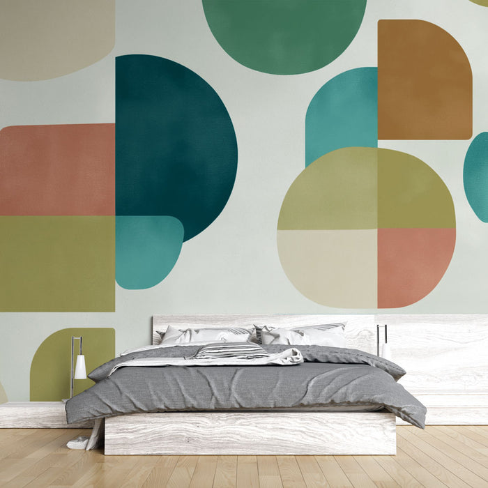 Une chambre moderne avec un papier peint abstrait aux formes géométriques colorées, mêlant des teintes de vert, bleu, beige et terracotta, créant une ambiance dynamique et contemporaine.