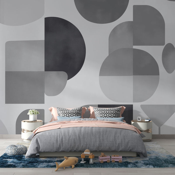 Une chambre moderne avec un papier peint géométrique en nuances de gris, mêlant cercles et carrés pour une ambiance contemporaine et apaisante.