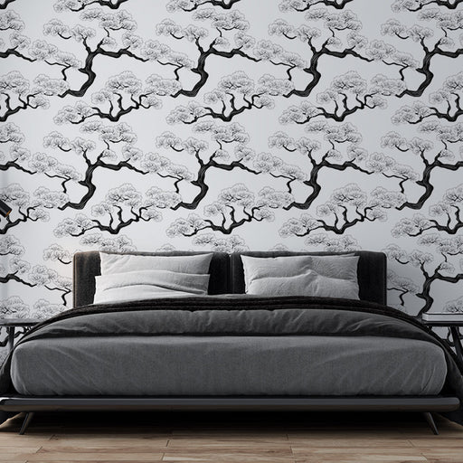 Une chambre moderne avec un papier peint représentant des branches d'arbres en noir et blanc, créant une atmosphère zen et élégante.