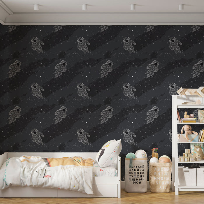 Une chambre d'enfant avec un papier peint noir illustré d'astronautes blancs flottant dans un univers étoilé, créant une ambiance ludique et imaginative.
