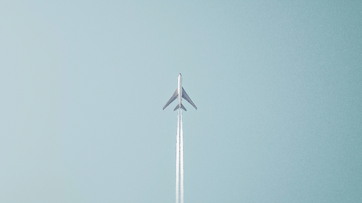 Papier peint avion Un avion survolant un ciel bleu clair
