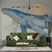 Un salon moderne avec un papier peint représentant une baleine stylisée en bleu sur fond clair, évoquant une ambiance apaisante et marine.