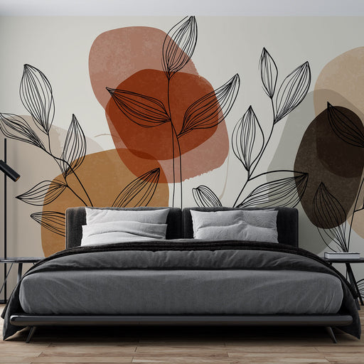 Une chambre moderne avec un papier peint aux motifs de feuilles stylisées en noir sur des formes abstraites dans des teintes chaudes, créant une ambiance chaleureuse et accueillante.
