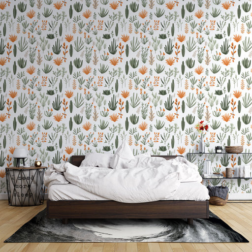 Une chambre apaisante avec un papier peint botanique aux motifs colorés de plantes vertes et fleurs orange sur fond blanc.