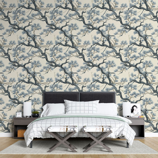 Une chambre élégante avec un papier peint floral représentant des branches d'arbres en bleu et beige, créant une atmosphère apaisante et naturelle.