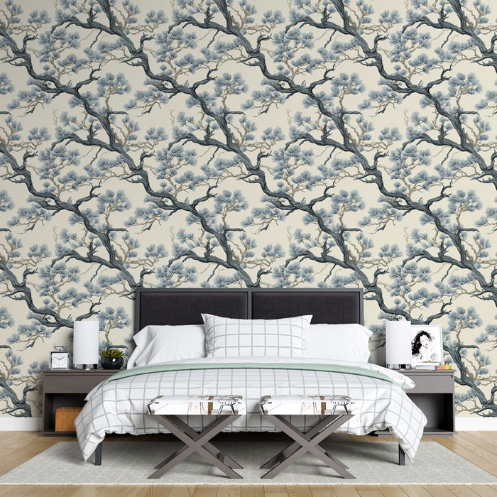 Une chambre élégante avec un papier peint floral représentant des branches d'arbres en bleu et beige, créant une atmosphère apaisante et naturelle.