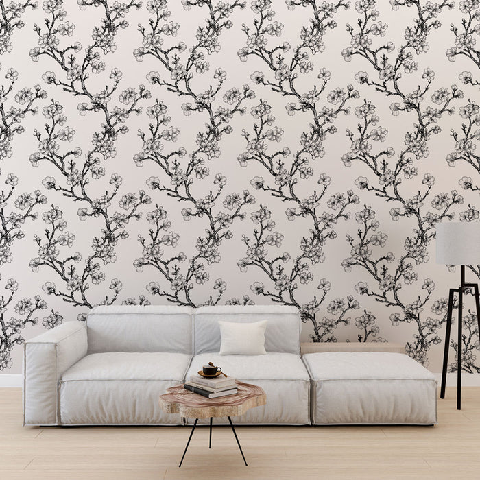 Un salon moderne avec un papier peint floral noir et blanc représentant des branches fleuries, créant une atmosphère élégante et apaisante.