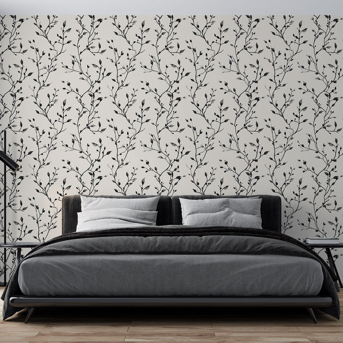 Une chambre moderne avec un papier peint délicat aux motifs de branches noires sur fond clair, créant une atmosphère apaisante et élégante.