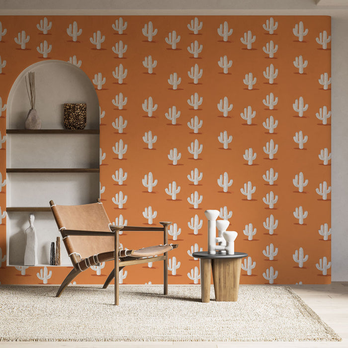 Une pièce moderne avec un papier peint orange vif orné de motifs de cactus blancs, créant une ambiance joyeuse et chaleureuse.