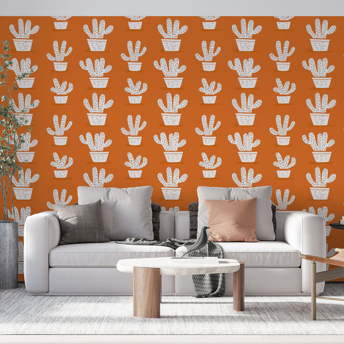 Un salon moderne avec un papier peint orange vif orné de motifs de cactus en pots blancs, créant une ambiance joyeuse et accueillante.