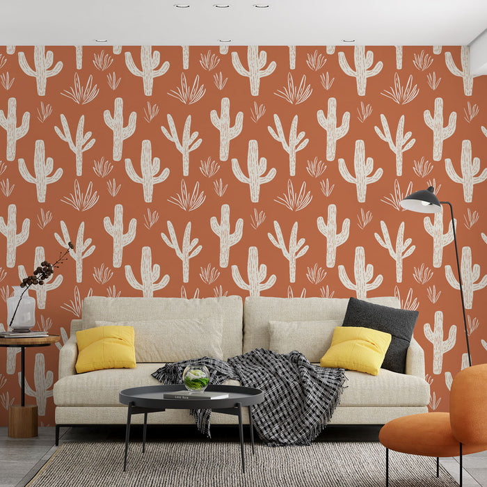 Un salon moderne avec un papier peint terracotta illustrant des cactus blancs, créant une ambiance chaleureuse et accueillante.