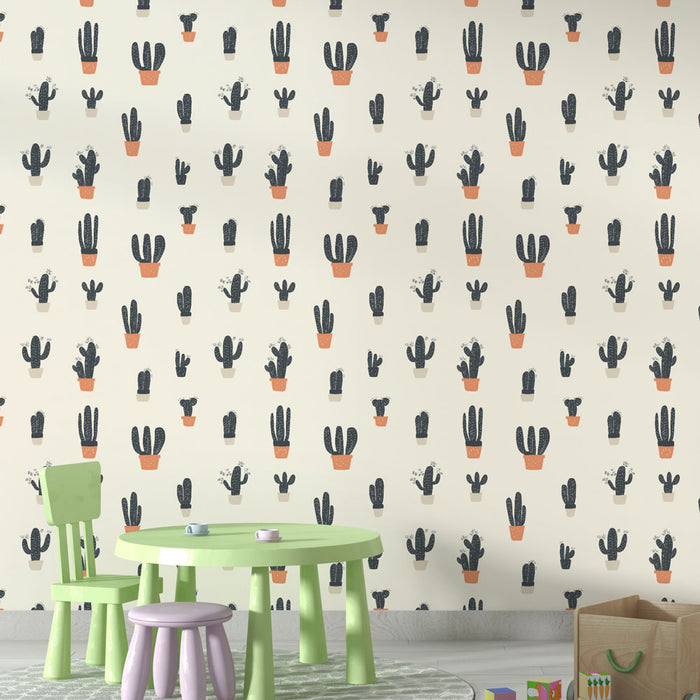 Une salle de jeux avec un papier peint illustrant des cactus en pots aux teintes noires et terracotta, créant une ambiance ludique et chaleureuse.