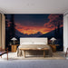 Une chambre moderne avec un papier peint représentant un paysage montagneux au coucher de soleil, créant une atmosphère chaleureuse et apaisante.