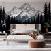 Une chambre moderne avec un papier peint représentant des montagnes majestueuses en noir et blanc, créant une atmosphère apaisante et naturelle.