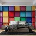 Une chambre moderne avec un papier peint coloré représentant des blocs texturés aux teintes vives, créant une ambiance dynamique et joyeuse.