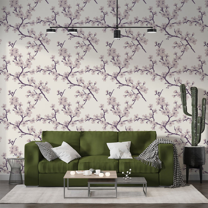 Un salon moderne avec un papier peint floral aux motifs de branches de cerisier en fleurs sur fond clair, créant une ambiance douce et apaisante.