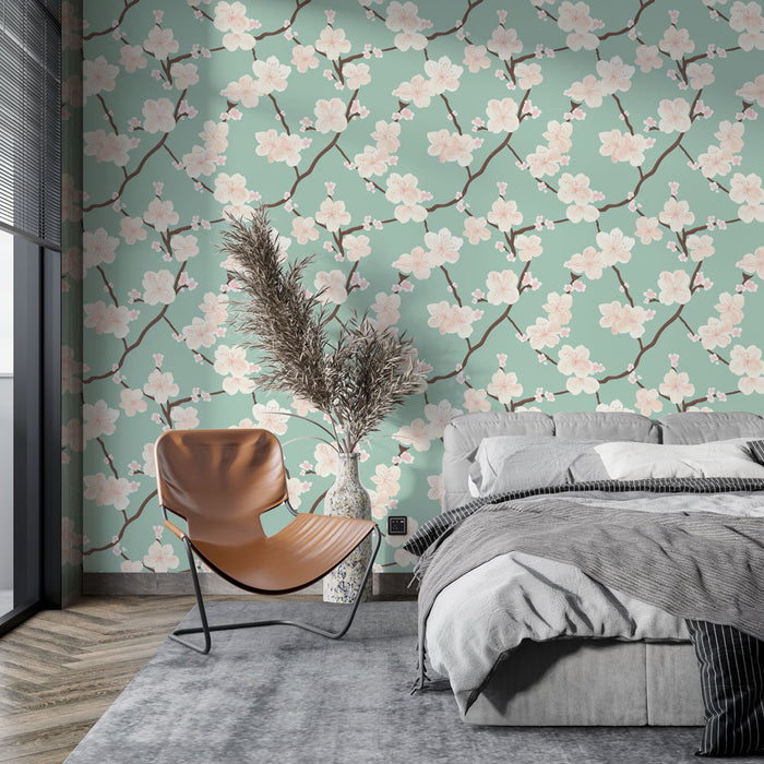 Une chambre moderne avec un papier peint floral aux motifs de fleurs roses sur fond vert menthe, créant une atmosphère douce et apaisante.