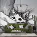 Un salon moderne avec un papier peint illustratif représentant un chat aux grands yeux, créant une ambiance chaleureuse et artistique.