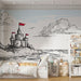 Une chambre d'enfant avec un papier peint illustrant un château en bord de mer, aux lignes dessinées en noir et rouge, créant une ambiance ludique et imaginative.