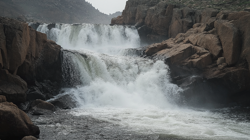 Papier peint chute d'eau Cascade majestueuse entourée de rochers naturels