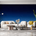 Un salon moderne avec un papier peint représentant un ciel étoilé dégradé de bleu nuit, créant une ambiance sereine et contemplative.