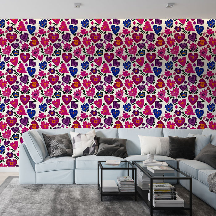 Un salon contemporain avec un papier peint coloré aux motifs de cœurs et de fleurs dans des tons vifs de rose, violet et bleu, créant une ambiance joyeuse et dynamique.
