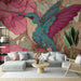 Un salon élégant avec un papier peint représentant un colibri coloré sur fond de fleurs roses, créant une ambiance vivante et artistique.
