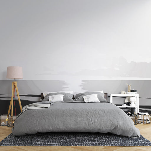 Une chambre moderne avec un papier peint représentant un paysage minimaliste en nuances de gris, créant une ambiance apaisante et élégante.