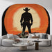 Un salon contemporain avec un papier peint représentant un cow-boy en silhouette devant un grand soleil orange, créant une ambiance audacieuse et dynamique.
