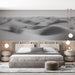 Une chambre moderne avec un papier peint représentant un paysage de dunes de sable en noir et blanc, créant une atmosphère apaisante et minimaliste.