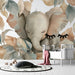 Une chambre d'enfant avec un papier peint illustrant un éléphant doux entouré de feuilles pastel, créant une ambiance tendre et apaisante.