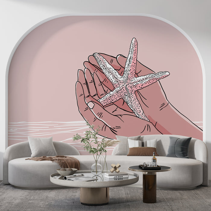 Un salon moderne avec un papier peint illustratif représentant des mains tenant une étoile de mer sur fond rose, créant une ambiance douce et apaisante.