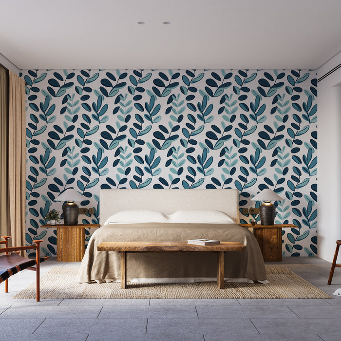 Une chambre moderne avec un papier peint aux motifs de feuillages dans des teintes de bleu et vert sur fond clair, créant une atmosphère fraîche et apaisante.