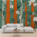 Un salon moderne avec un papier peint aux motifs botaniques stylisés, mêlant des teintes vertes, orange et blanches pour une ambiance vivante et chaleureuse.