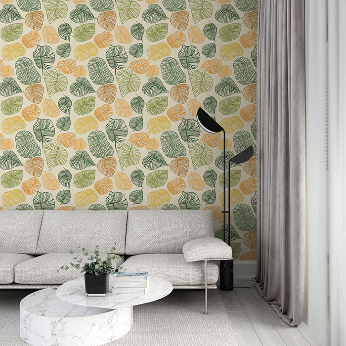 Un salon moderne avec un papier peint aux motifs de feuilles colorées dans des teintes vertes, jaunes et orange, créant une ambiance fraîche et accueillante.