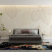 Papier peint feuillage délicat avec feuilles linéaires sur fond crème pour chambre moderne.