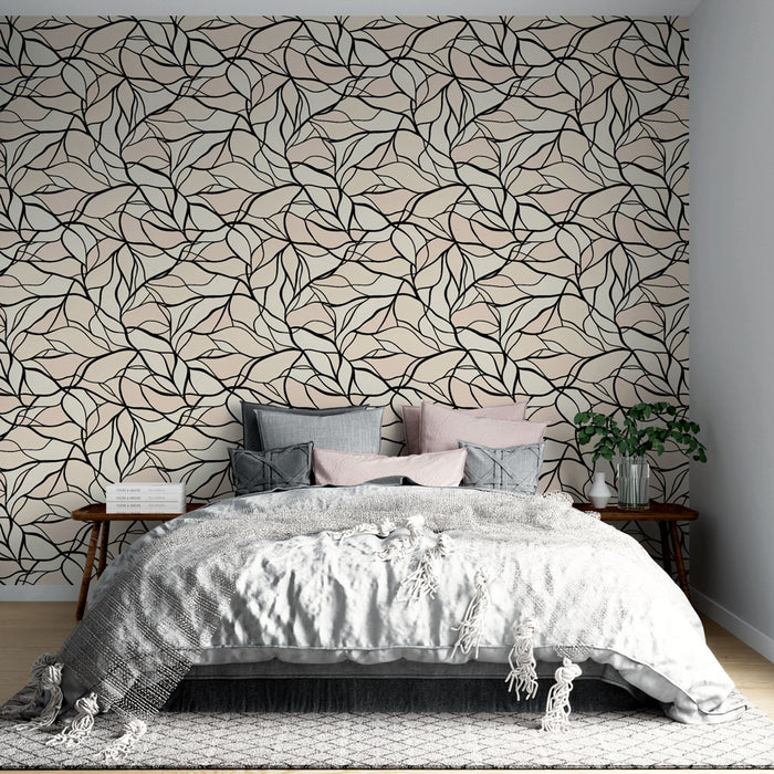 Une chambre élégante avec un papier peint aux motifs de feuilles noires sur fond beige, créant une ambiance apaisante et naturelle.