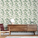 Un salon moderne avec un papier peint aux motifs de feuilles vertes délicates sur fond clair, créant une atmosphère apaisante et naturelle.