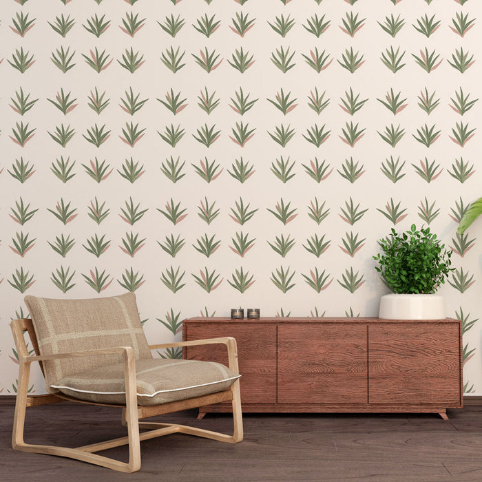 Une pièce moderne avec un papier peint aux motifs de feuilles stylisées vertes et roses sur fond crème, créant une atmosphère fraîche et naturelle.