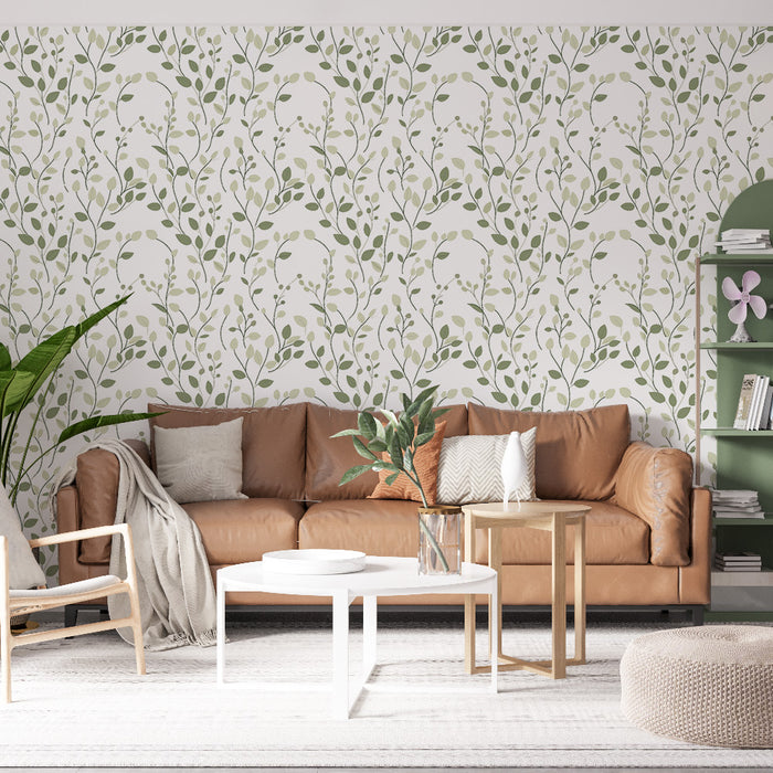 Un salon moderne avec un papier peint floral aux motifs de feuillage vert sur fond blanc, créant une ambiance fraîche et apaisante.