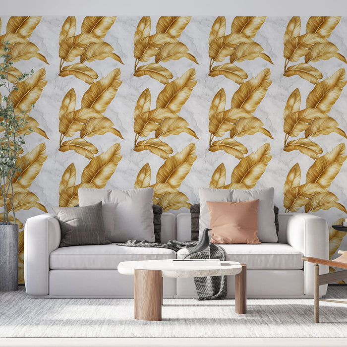 Un salon moderne avec un papier peint aux motifs de grandes feuilles dorées sur fond marbré, créant une ambiance élégante et chaleureuse.