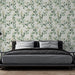 Une chambre moderne avec un papier peint floral aux motifs de feuilles vertes sur fond clair, créant une atmosphère apaisante et naturelle.